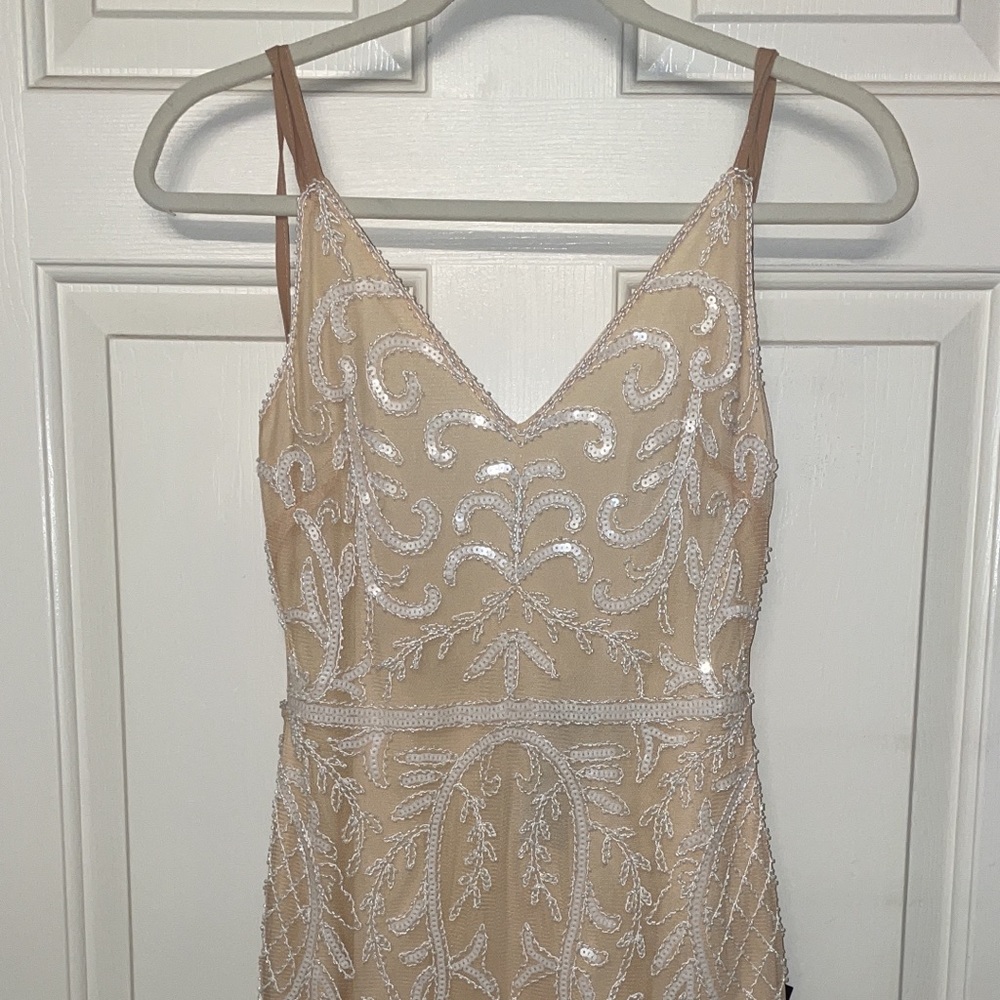Nude fitted dress with bead design.